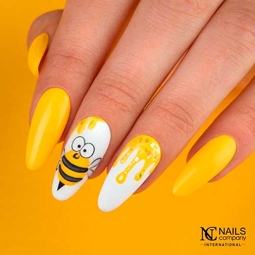 Long Almond Shaped Bright Yellow Honey Bee's Summer Nail Design with Two White Accents Adorned with Honey and Bee Shape