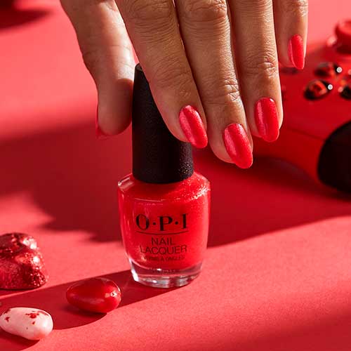 Medium pearlescent red nails use OPI nail polish Heart and Con soul from OPI Xbox Spring Nail Colors 2022 collection