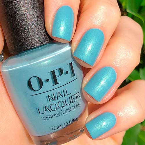 Short square shaped shimmery sage green nails use Sage Simulation OPI Nail Polish from OPI Xbox spring nail colors 2022