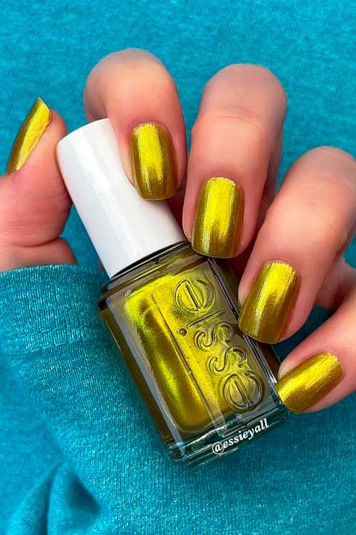 Essie Nail Polish Tropic Low from Summer 2022 Collection Which Is Mossy Green Nail Polish with Gold Duochrome Pearls