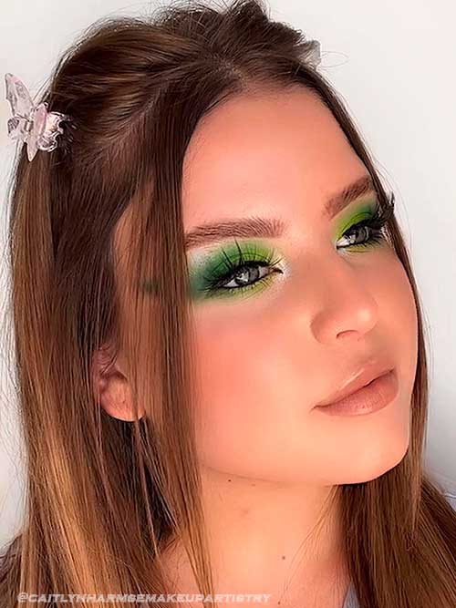 Green bold eye makeup look and nude lips for summer 2022