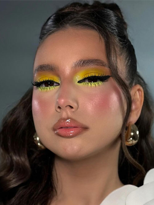 Neon yellow eyeshadow with glossy nude lips creates a bold is one of playful summer makeup looks that's fresh and chic. Neon yellow eyeshadow with glossy nude lips creates a bold is one of playful summer makeup looks that's fresh and chic.