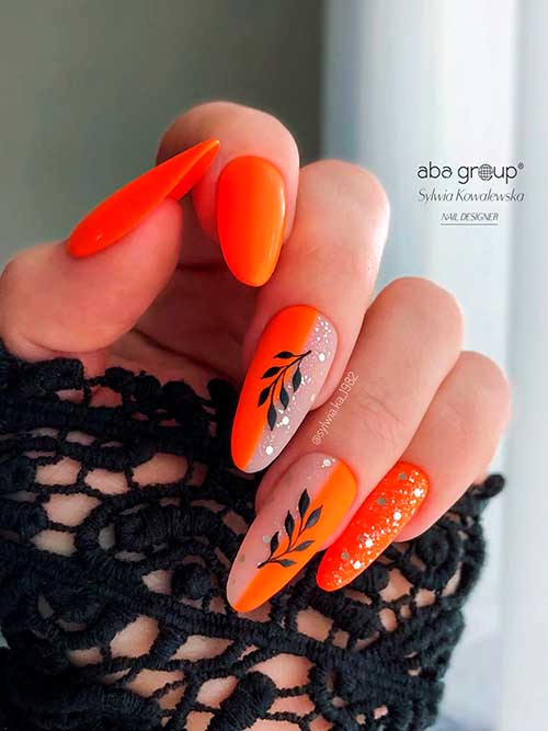 Sparkling Neon Orange Nails with Black Leaf Nail Art on Two Accents for Summer 2022