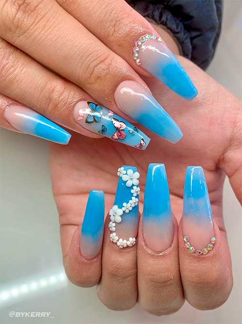 Long Light Blue Ombre Nails Coffin Shaped with Butterflies, Rhinestones, and White Flowers