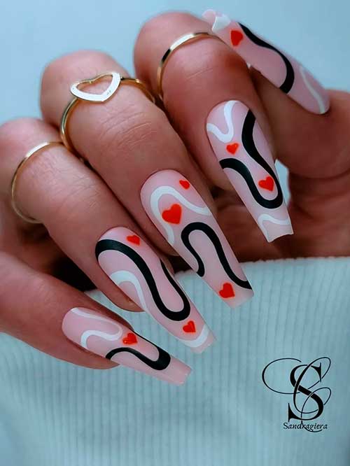 Long Coffin Shaped Valentine’s Nails 2023 with Black and White Swirls and Red Hearts over Nude Base Color