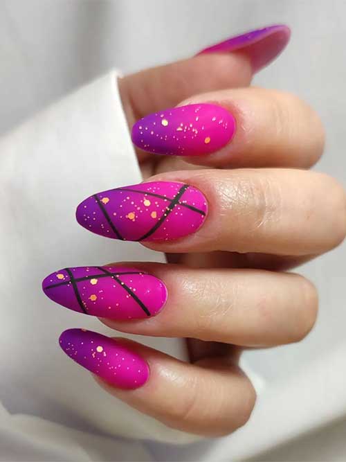 Long almond-shaped matte pink to purple ombre nails 2023 with gold glitter and black stripes