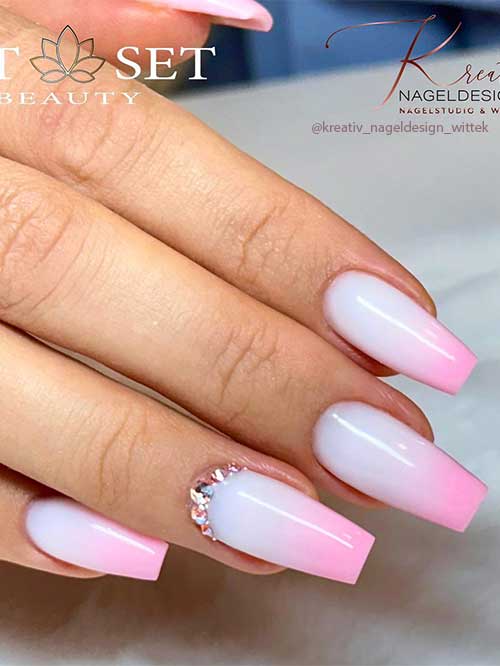 Long coffin light pink ombre nails 2023 with rhinestones on an accent nail