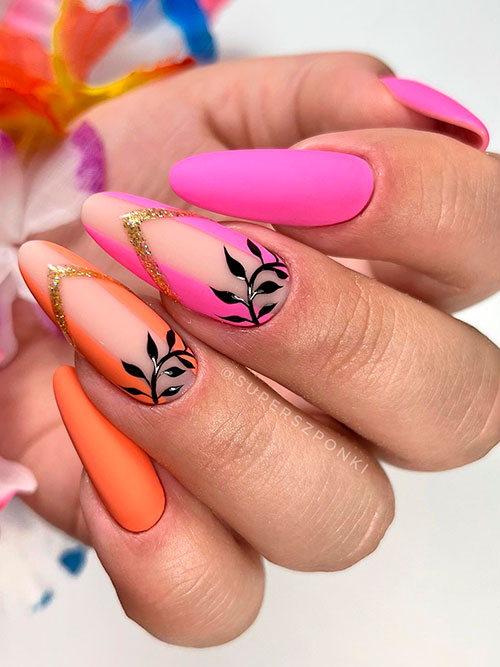 Long Neon Pink Nails with Orange Neon Accents and Adorned with Black Leaf Nail Art and Gold Glitter