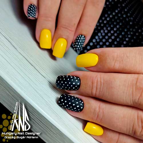 Medium square shaped black and yellow nails with polka dot accents