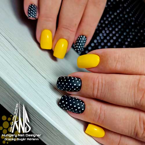 Black and yellow nails with polka dot accents Medium square shaped black and yellow nails with polka dot accents