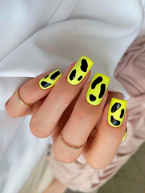 Medium square shaped bright yellow nails with black abstract nail art for summertime