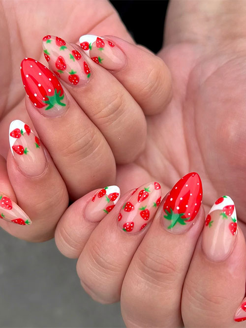 Long nude almond-shaped nails adorned with tiny strawberries with two accent white classic French tips Long nude almond-shaped nails adorned with tiny strawberries with two accent white classic French tips