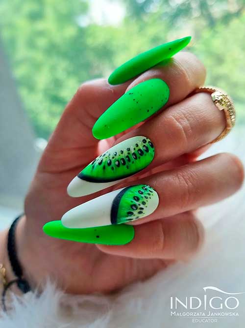 Long almond matte neon green nails with black speckles and two accent kiwi fruit nails