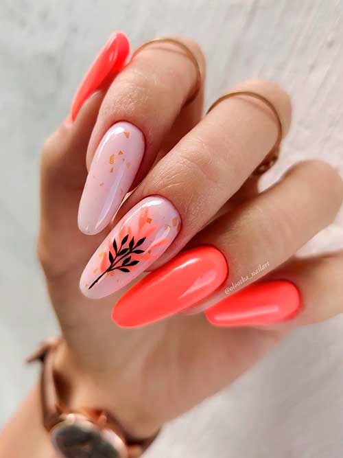 Long Round Shaped orange nails with a fall leaf nail art on one of two accent nude nails