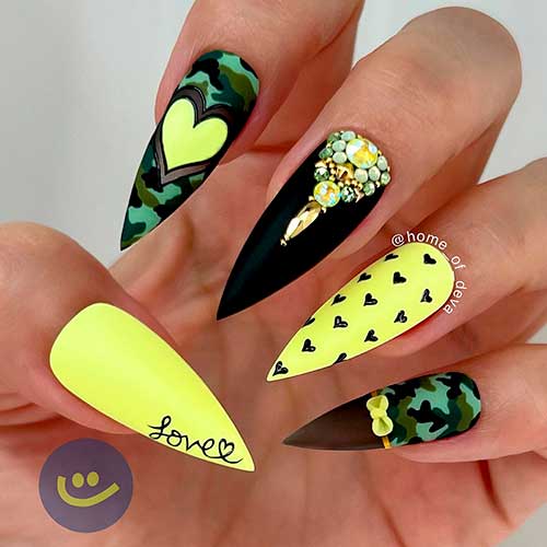 Stiletto black and yellow nails with rhinestones, love word, and tiny heart shapes