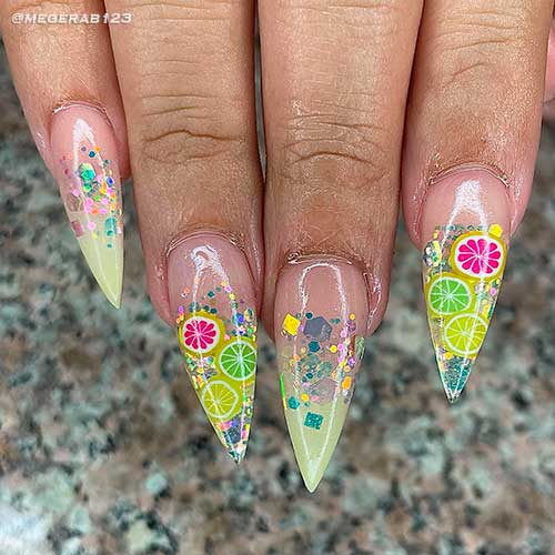 Stiletto clear and ombre nails with glitter and citrus nail art design Stiletto clear and ombre nails with glitter and citrus nail art design