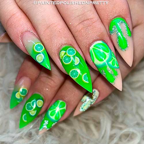 Stiletto glow-in-the-dark lime citrus nails with silver glitter for summer 2022
