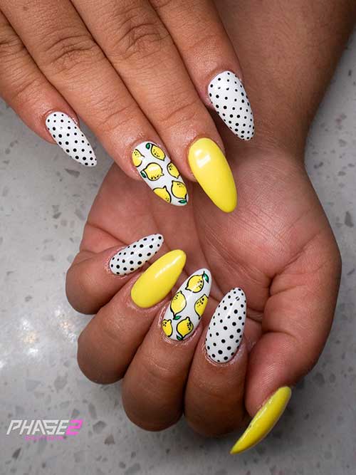 White polka dot nails with citrus nail art Medium almond shaped white polka dot nails with citrus nail art and accent yellow nail