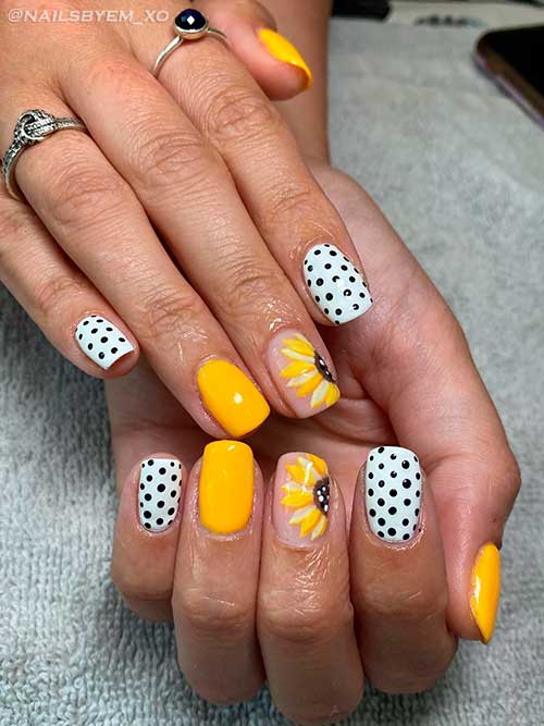 Yellow nail design with polka dot and sunflower nail art