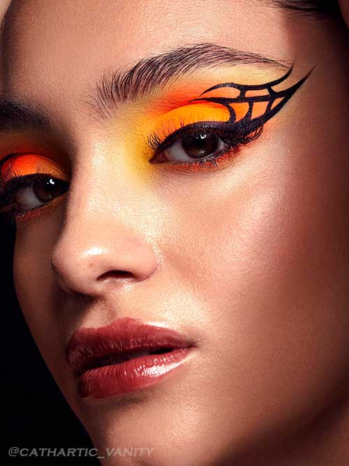 Black Graphic Liner with neon orange and yellow eyeshadows Black graphic liner with neon orange and yellow eyeshadows for Fall 2022