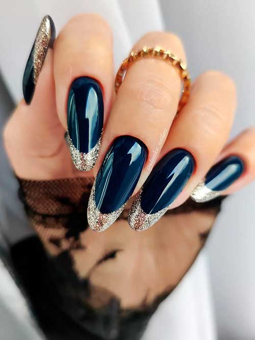 Long almond shaped navy blue nails 2023 with gold glitter French tips that suit new year celebration