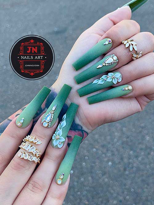 Long coffin shaped matte ombre olive nails with gold rhinestones and leaf nail art on accent nail
