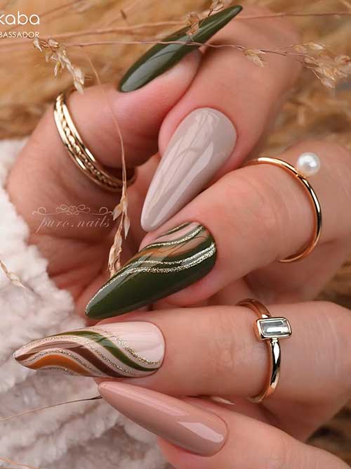 Long almond olive and nude nails, with gold glitter and multicolored swirl nail art for fall season