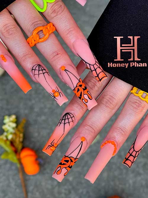 Pumpkin Drip and Spider Web Nail Art Design Long Halloween Pumpkin Drip and Spider Web Nail Art Design on Nude and Orange ombre Nails