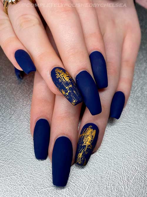 Long matte coffin navy blue nails with gold foil on an accent nail for Fall 2022