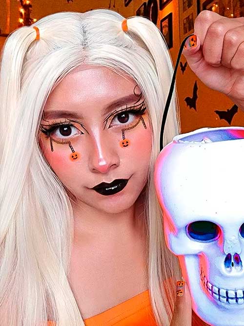 Black Halloween Eyeliner Makeup Look Consists of cobweb and Hanging Pumpkins