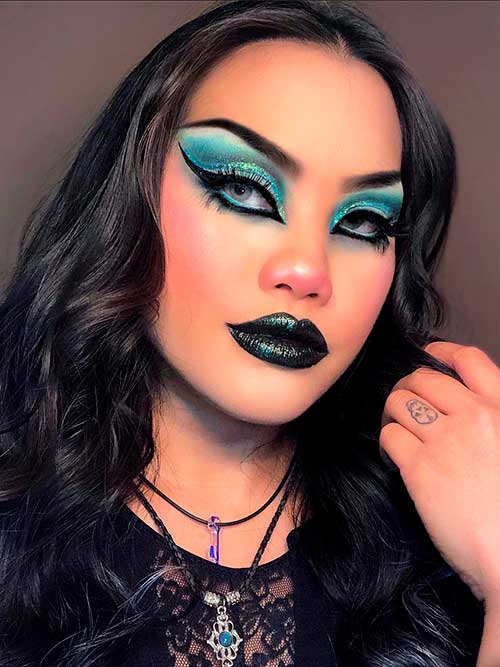 Gothic makeup features blue goth eyeshadow and dark glitter lips Gothic makeup features blue goth eyeshadow and dark glitter lips