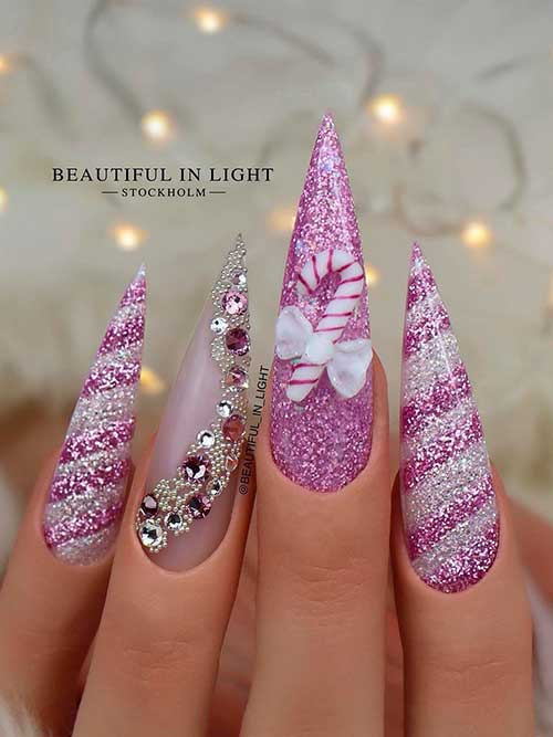 Glamorous purple Christmas nail idea Glamorous Long Stiletto purple Christmas nail idea with rhinestones and candy cane accent nails