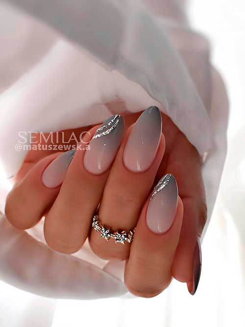 Medium almond-shaped gray ombre nails with a little glitter on two accent nails for the winter season