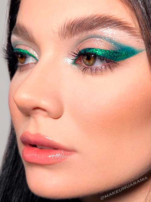 Winged Eyes Winged Eyes look uses green metallic eyeliner with emerald eyeshadow