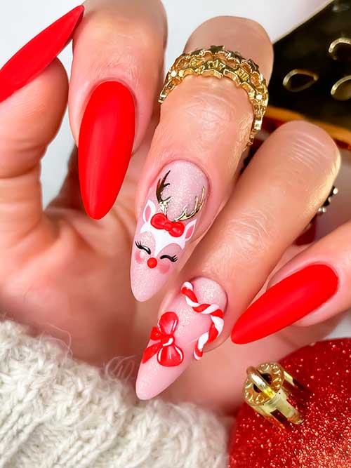 Almond matte red Christmas Nails with cute reindeer and candy cane on two nude pink accent nails