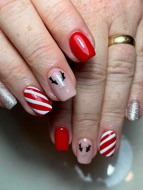 Short Red Christmas Acrylic Nails with Candy Cane, Reindeer, and Glitter Accent Nails