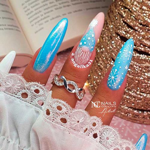 Blue Winter Nail Design with A Holo Touch Long Almond Blue Winter Nail Design With A Holo Touch, Snowflakes, Gnome, And Nude And White Accent Nails