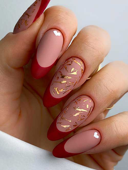 Long almond shaped matte dark red French tip nails with gold patches and white hearts for Valentine’s Day