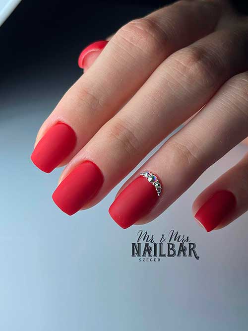 Short Matte Red Nails with Silver Rhinestones on Ring Fingernail