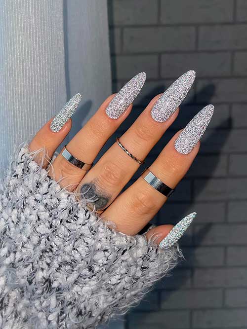 Long almond shaped Silver glitter new years nails 2023