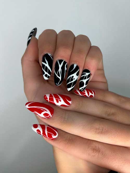 Abstract Red and Black Nail Design Long Almond Shaped red and black nails with white abstract nail art