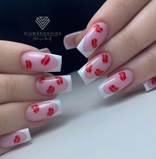 Cute classic white French manicure with many red lip nail art all over the nude pink area