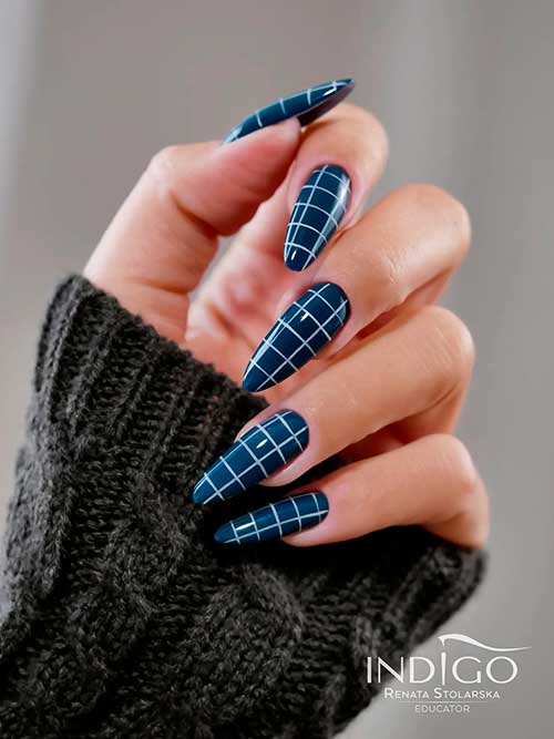 Long Almond Shaped Dark Blue Nails with White Criss Crossed Nail Art for Winter Season