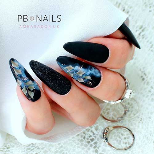 Long Almond Shaped Matte Black Nails with Glitter, White Smoke, and Leaf Nail Art on Two Accent Nails