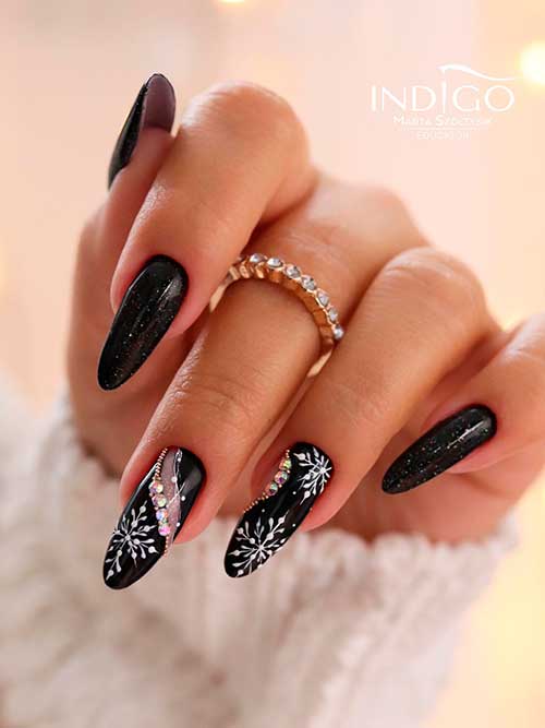 Long Almond Shaped Winter Black Nails with Snowflakes, Glitter, and Rhinestones are the Best Black Nail Designs to Try