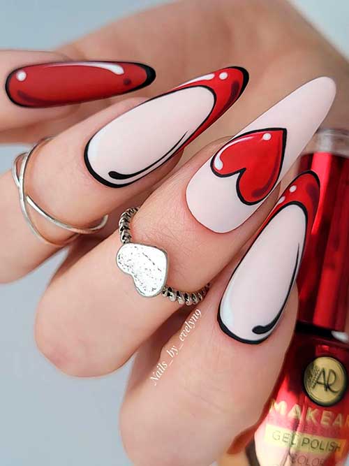 Valentine’s Pop Art Nails Valentines pop art nails with two French accent nails and a big red heart shape on the middle fingernail