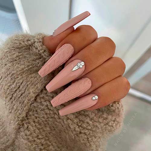 Long glossy and matte nude coffin nails with sweater nail art and silver rhinestones
