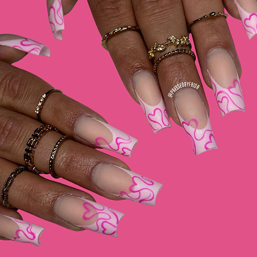 Long light pink French tip nails with hot pink swirls forming heart shapes are one of the best Valentine nail designs to try Long light pink French tip nails with hot pink swirls forming heart shapes are one of the best Valentine nail designs to try