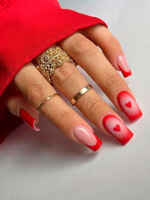 Long square shaped matte red French Valentine’s nails with heart shapes are one of the best valentine nail designs