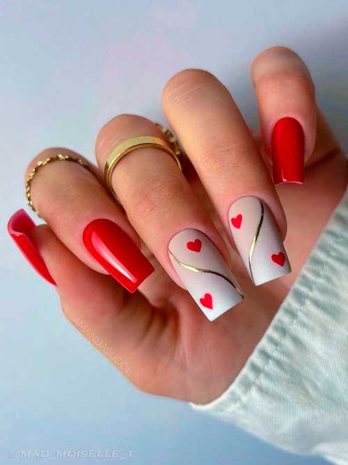 Glossy Red Valentines Nails with Hearts Long square shaped red valentine’s day nails with red heart shapes on two accent ombre nails